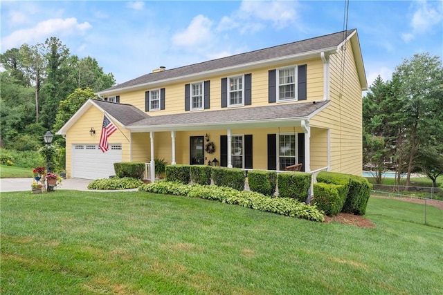 1083 Wash Lee Dr SW, Lilburn, GA 30047 - colonial-style house with covered porch, an attached garage, a front yard, and driveway