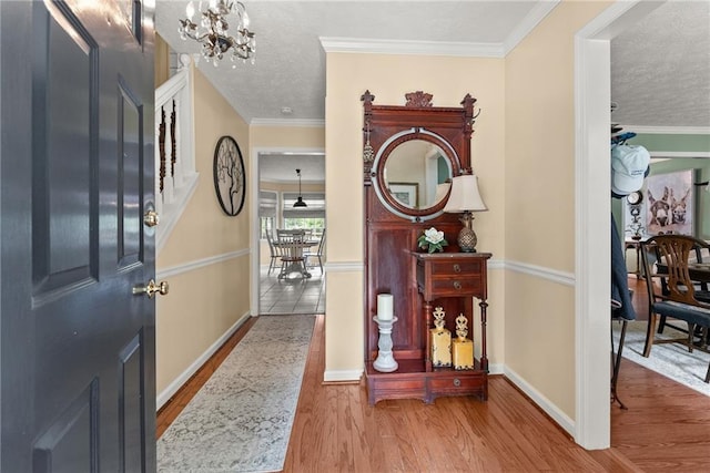 1083 Wash Lee Dr SW, Lilburn, GA 30047 - foyer entrance with a chandelier, wood finished floors, a textured ceiling, stairs, and ornamental molding