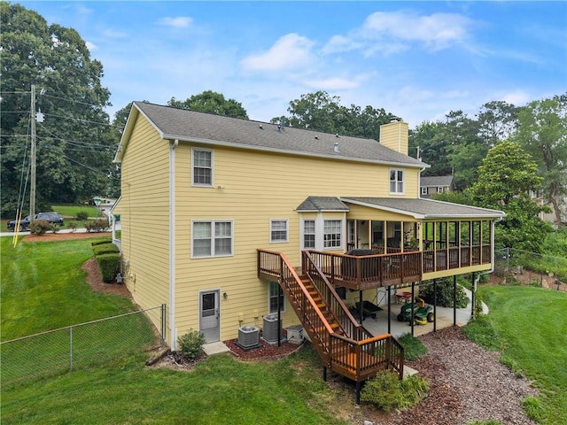 1083 Wash Lee Dr SW, Lilburn, GA 30047 - back of property featuring a chimney, a deck, a fenced backyard, a patio, and stairway