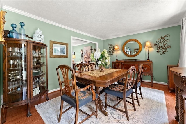 1083 Wash Lee Dr SW, Lilburn, GA 30047 - dining area with wood finished floors, a textured ceiling, and ornamental molding