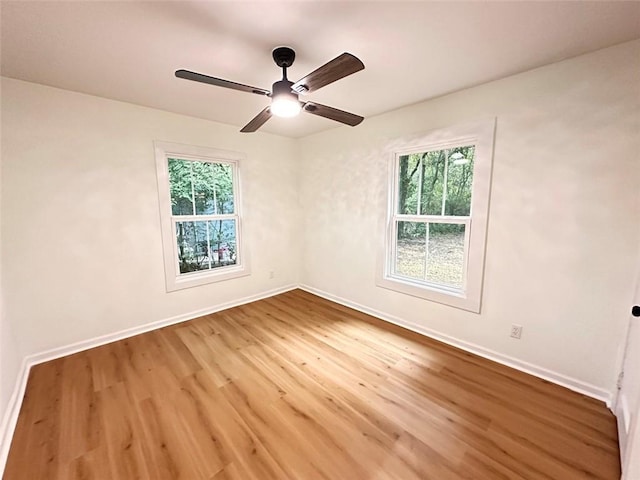 spare room featuring hardwood / wood-style flooring and ceiling fan