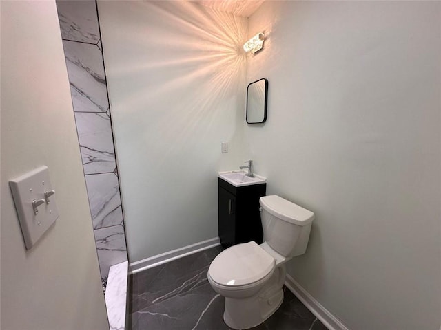 bathroom featuring tile patterned flooring, toilet, and vanity