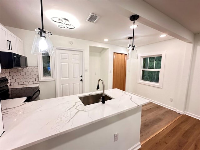 kitchen with black appliances, sink, decorative light fixtures, decorative backsplash, and dark hardwood / wood-style floors