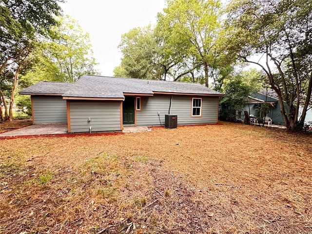 rear view of house featuring central air condition unit