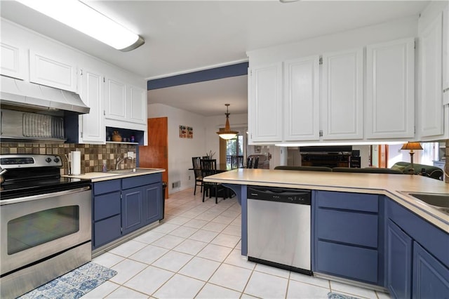 kitchen with backsplash, blue cabinets, stainless steel appliances, white cabinetry, and a sink