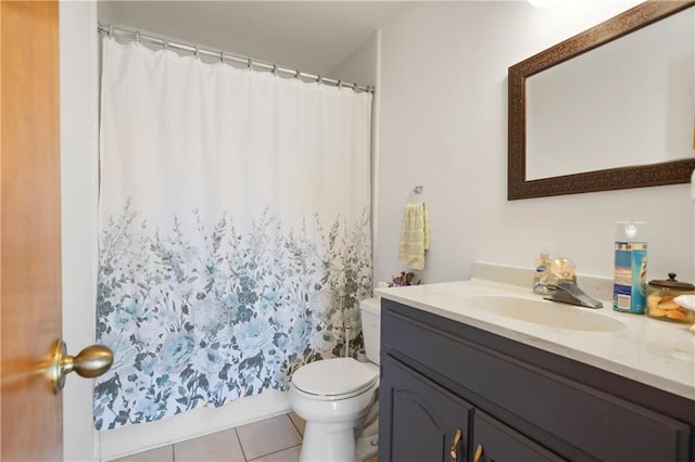bathroom featuring toilet, tile patterned flooring, and vanity