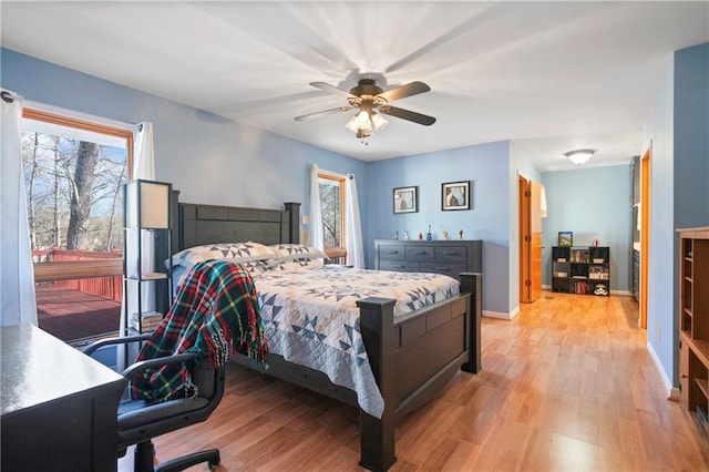 bedroom with ceiling fan, light wood-style flooring, and baseboards