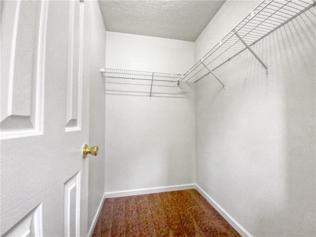 carpeted spare room with a textured ceiling, lofted ceiling, and ceiling fan