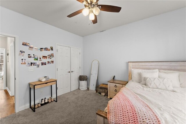 carpeted bedroom featuring a closet and a ceiling fan