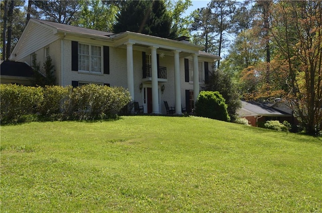 neoclassical home featuring a front yard