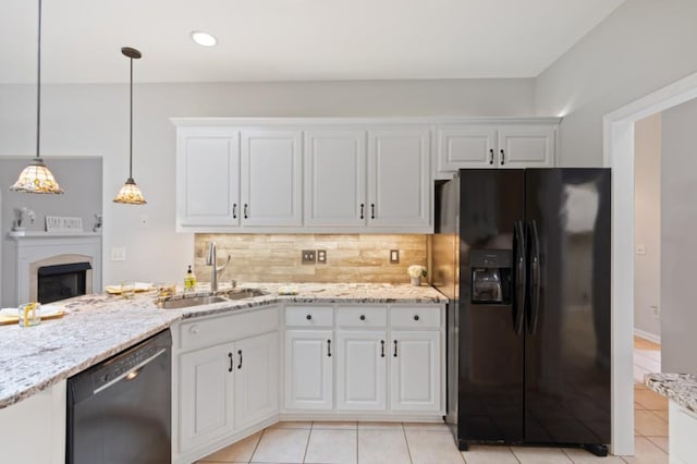 kitchen with pendant lighting, white cabinets, a sink, and black appliances