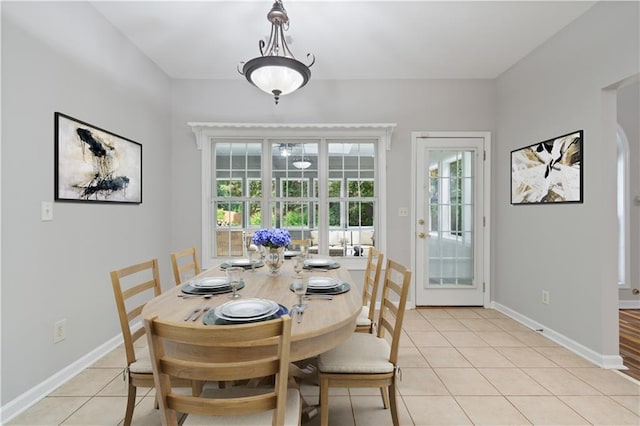 dining room with baseboards and light tile patterned floors