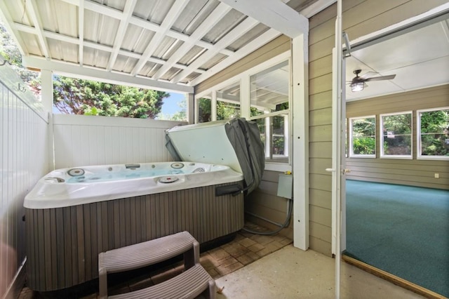 view of patio / terrace featuring fence and a hot tub