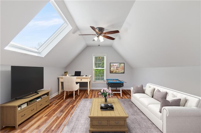 living area with lofted ceiling, wood finished floors, a ceiling fan, and baseboards