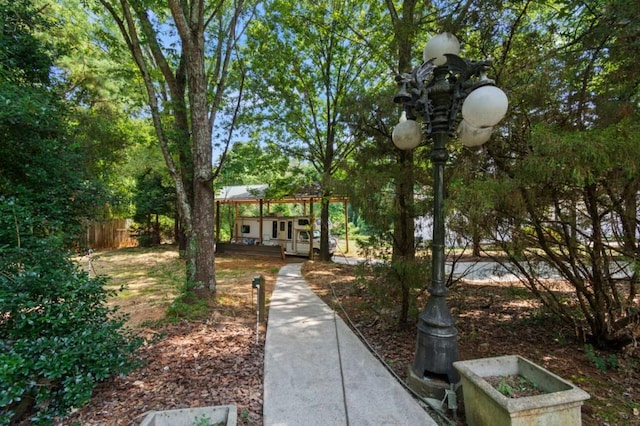 surrounding community with fence and an outdoor structure