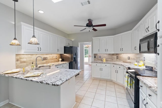 kitchen with pendant lighting, white cabinets, a peninsula, and black appliances