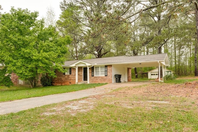 ranch-style home with brick siding, a front lawn, an attached carport, and driveway