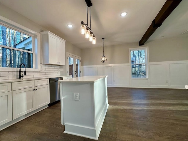 kitchen featuring a sink, dark wood-type flooring, dishwasher, and light countertops