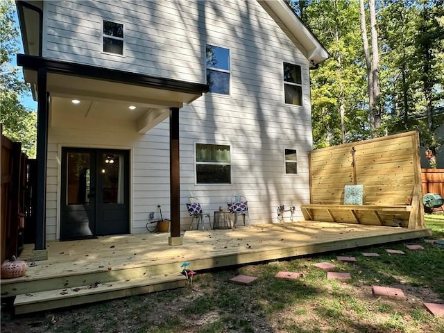 back of house with a deck, fence, and french doors