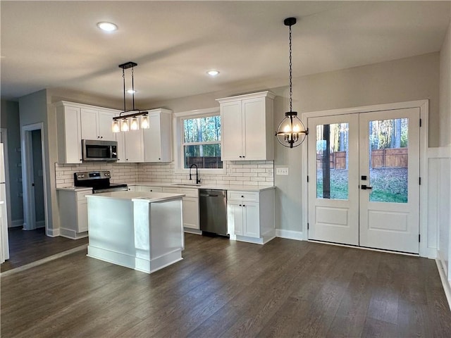 kitchen featuring a sink, stainless steel appliances, dark wood-style flooring, and white cabinetry