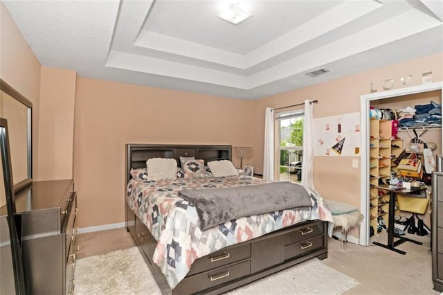 5865 El Segundo Way, Atlanta, GA 30349 - bedroom with a tray ceiling, light colored carpet, a walk in closet, and a closet