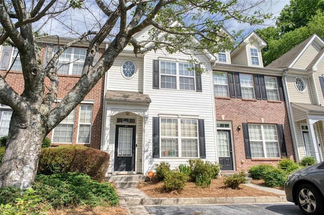 townhome / multi-family property featuring brick siding