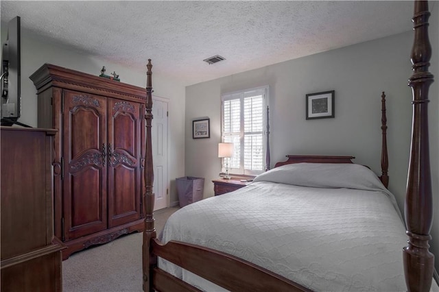 carpeted bedroom featuring a textured ceiling