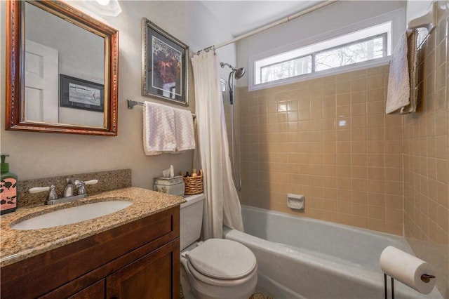 bathroom with toilet, shower / bath combo with shower curtain, and vanity