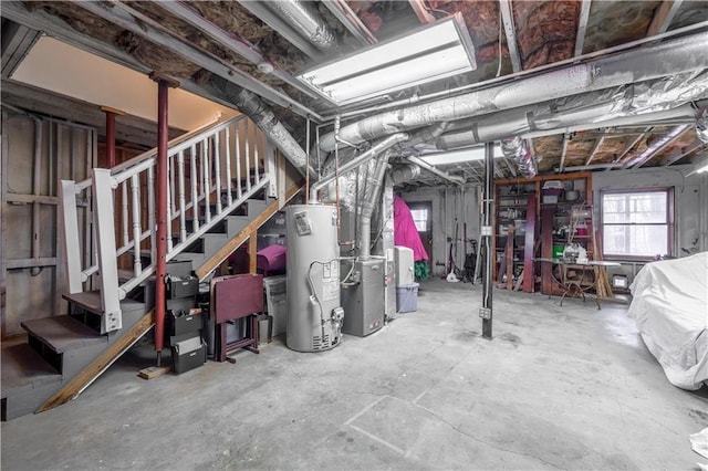 basement with gas water heater, stairs, and heating unit
