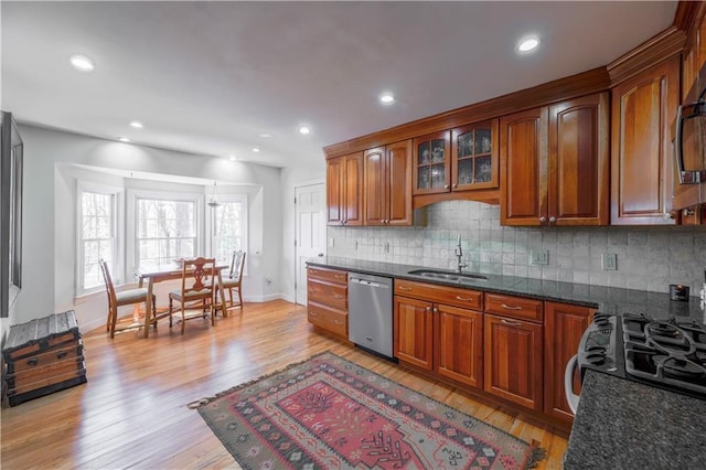 kitchen featuring stainless steel dishwasher, a sink, backsplash, brown cabinets, and recessed lighting