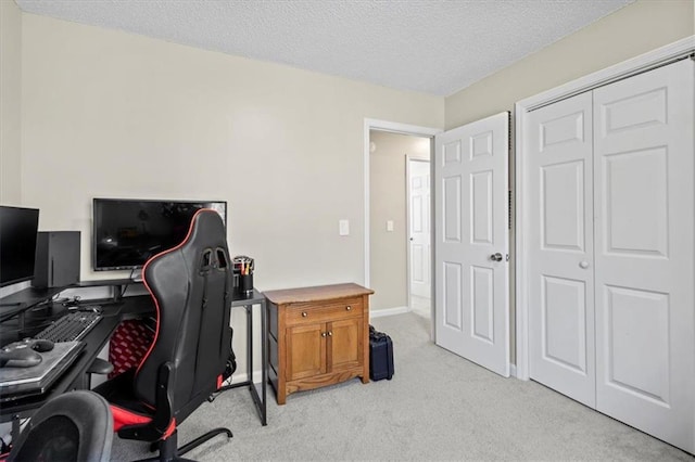 home office with light carpet, a textured ceiling, and baseboards