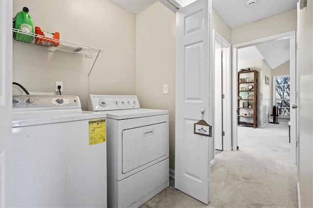 laundry room featuring laundry area, separate washer and dryer, and light colored carpet