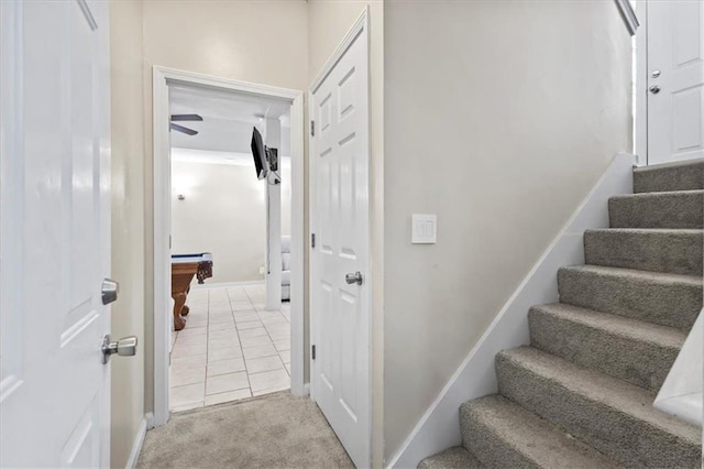 staircase featuring carpet floors and baseboards