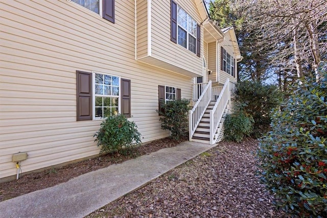 view of side of home with stairs