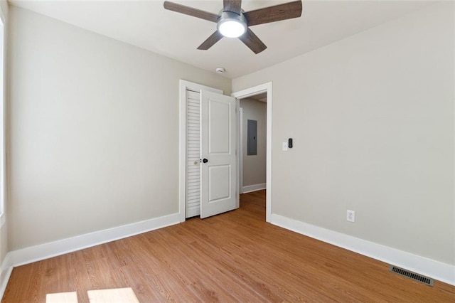 2081 Verbena St NW, Atlanta, GA 30314 - empty room with light wood-type flooring, a ceiling fan, electric panel, and a smoke detector