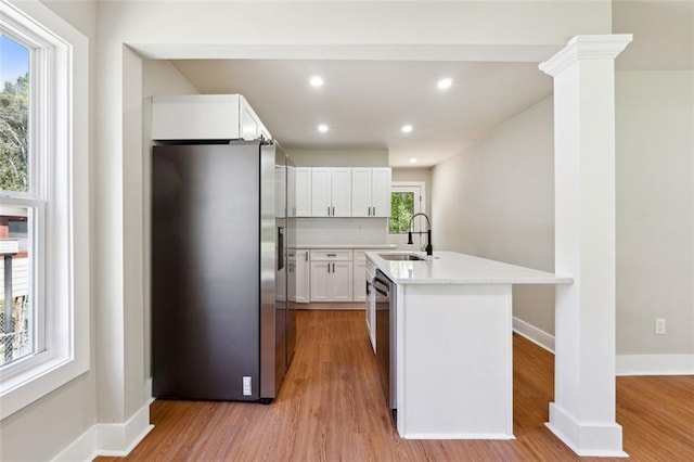 2081 Verbena St NW, Atlanta, GA 30314 - kitchen with stainless steel appliances, light wood-type flooring, light countertops, white cabinets, and recessed lighting