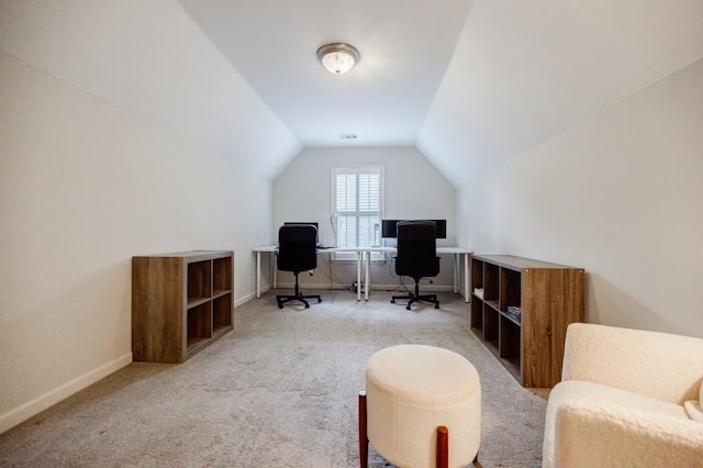 carpeted office featuring lofted ceiling