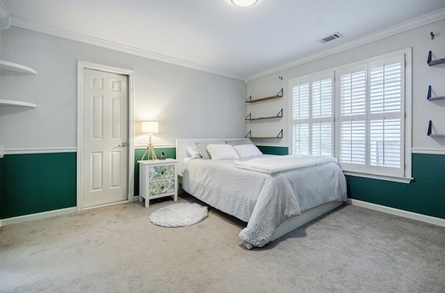 bedroom featuring ornamental molding and carpet