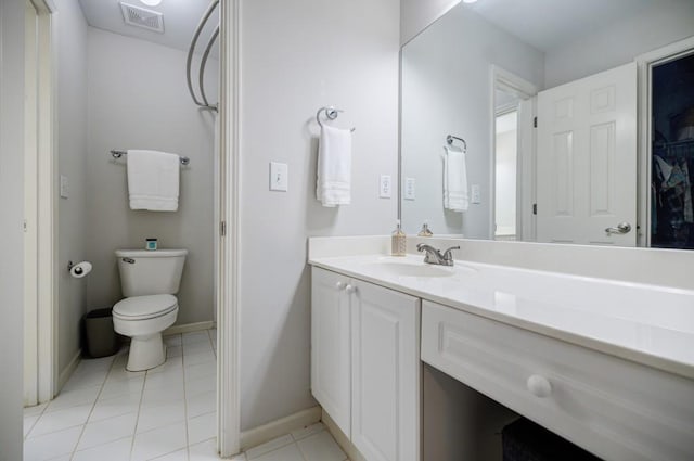 bathroom with tile patterned flooring, vanity, and toilet