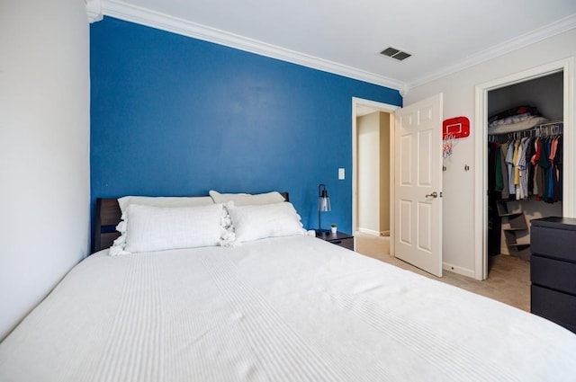 carpeted bedroom featuring crown molding, a walk in closet, and a closet