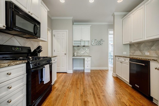 kitchen with white cabinetry, crown molding, stone countertops, light hardwood / wood-style floors, and black appliances