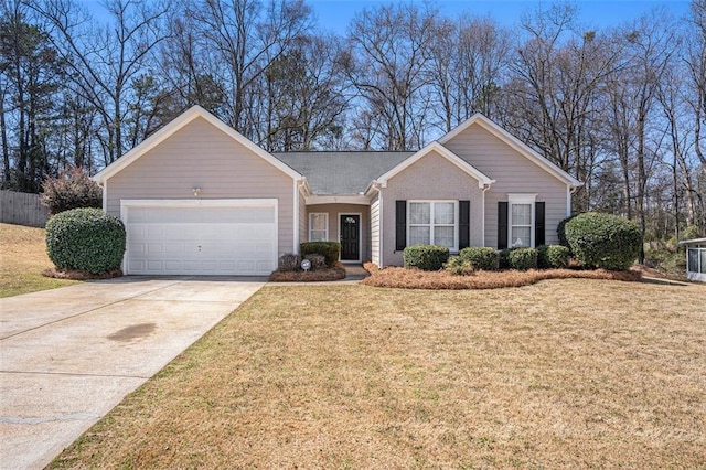 single story home featuring a front lawn, an attached garage, brick siding, and driveway