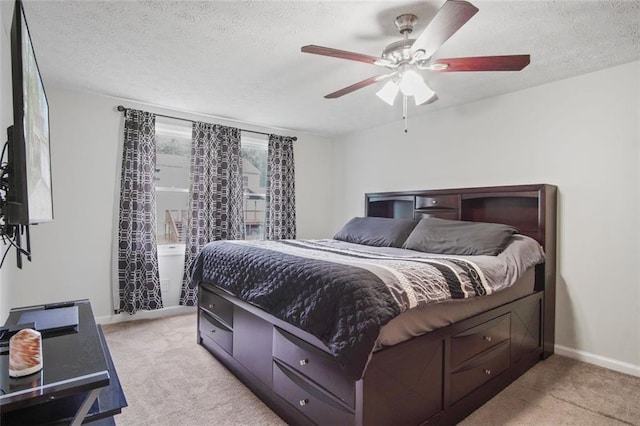 carpeted bedroom with a textured ceiling and ceiling fan