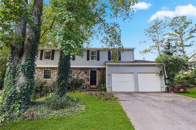 view of front of home with a front yard and a garage