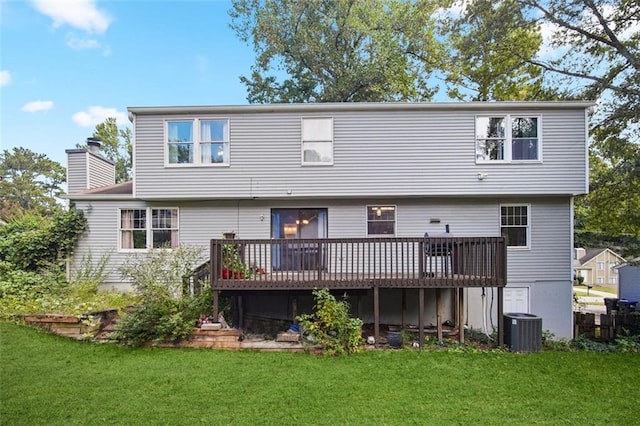 back of property featuring central air condition unit, a wooden deck, and a yard