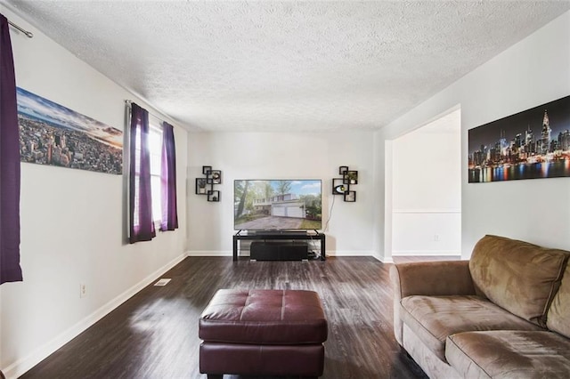 living room with a textured ceiling and wood-type flooring