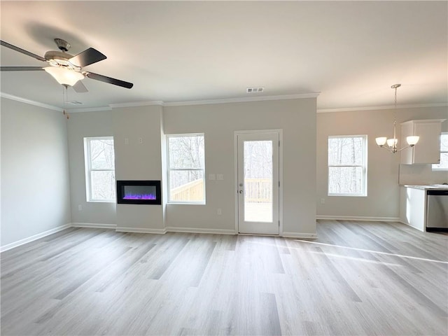 unfurnished living room with visible vents, baseboards, ceiling fan with notable chandelier, a glass covered fireplace, and light wood-style flooring