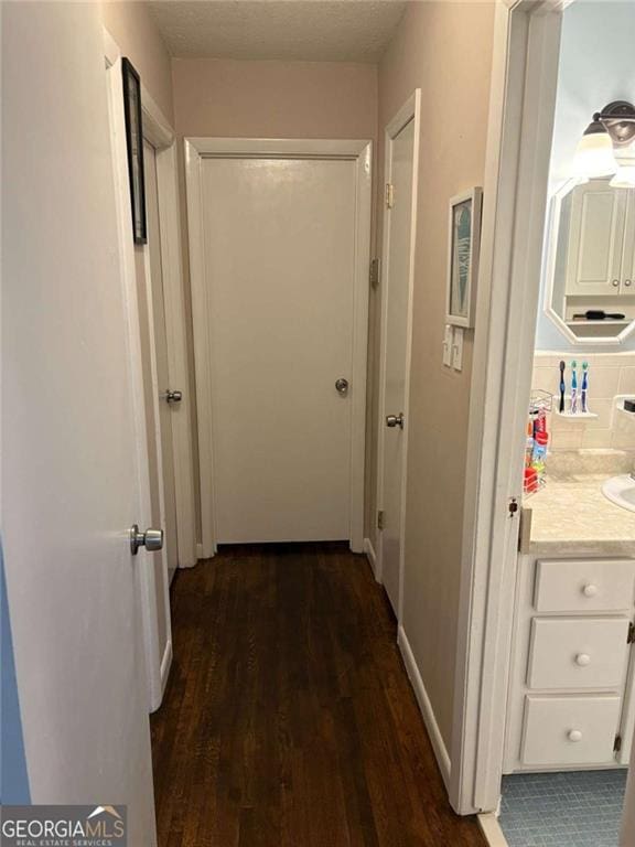 corridor with dark hardwood / wood-style floors