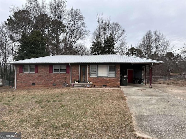 ranch-style home with a front yard and a carport