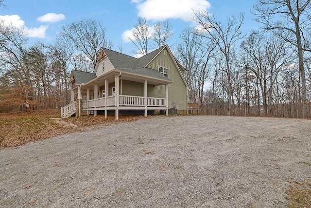 view of front of home with a porch and central AC